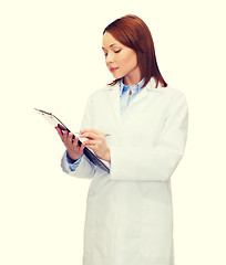 Image showing smiling female doctor with clipboard