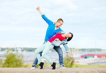 Image showing couple of teenagers dancing outside