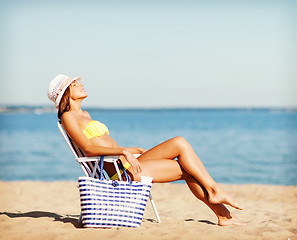 Image showing girl sunbathing on the beach chair