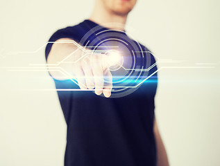 Image showing male hand touching virtual screen