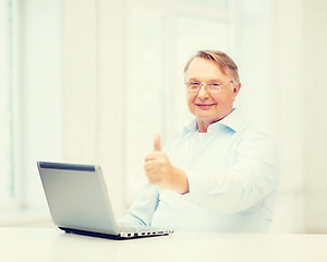 Image showing old man with laptop computer showing thumbs up
