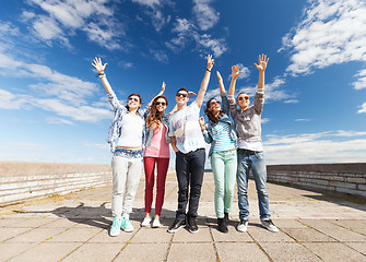 Image showing group of teenagers holding hands up