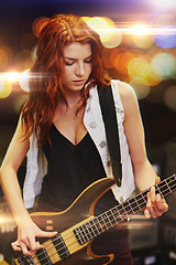 Image showing red haired woman playing guitar on stage