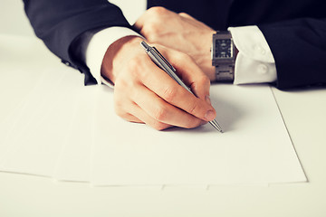 Image showing businessman writing something on the paper