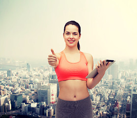 Image showing sporty woman with tablet pc computer