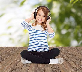 Image showing happy girl with headphones listening to music