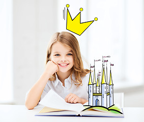 Image showing smiling girl reading fairytales at home