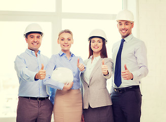 Image showing happy business team in office showing thumbs up