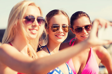 Image showing group of smiling women making selfie on beach