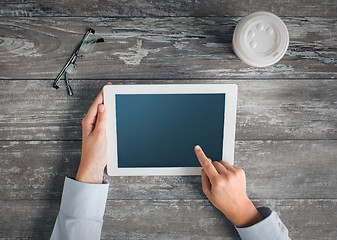 Image showing close up of hands with tablet pc and coffee