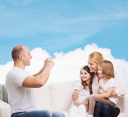 Image showing happy family with camera at home