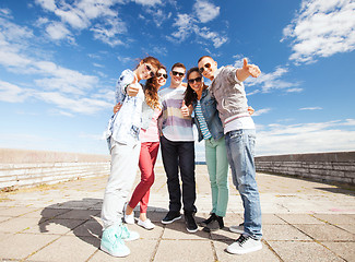 Image showing teenagers showing thumbs up