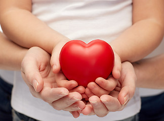 Image showing close up of woman and girl hands holding heart