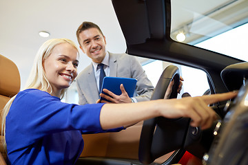 Image showing happy woman with car dealer in auto show or salon