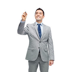 Image showing happy businessman in suit writing something