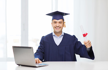 Image showing smiling adult student in mortarboard with diploma