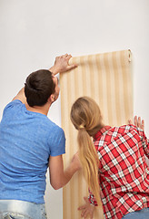 Image showing close up of couple holding wallpaper