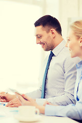 Image showing smiling businessman working in office