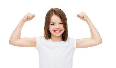 Image showing little girl in blank white t-shirt showing muscles