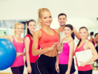 Image showing smiling sporty woman with smartphone