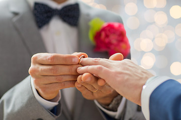 Image showing close up of male gay couple hands and wedding ring