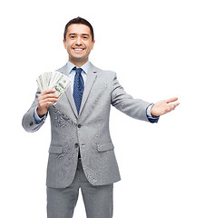 Image showing smiling businessman with american dollar money