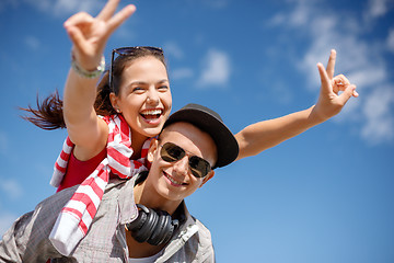 Image showing smiling teenagers in sunglasses having fun outside