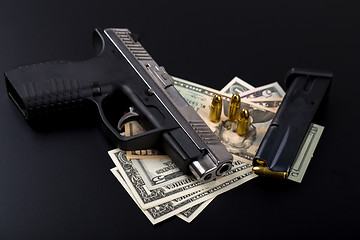 Image showing gun with bullet on US dollar banknotes