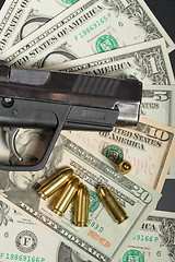 Image showing gun with bullet on US dollar banknotes