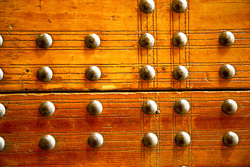 Image showing nail dirty stripped paint in  brown wood door 