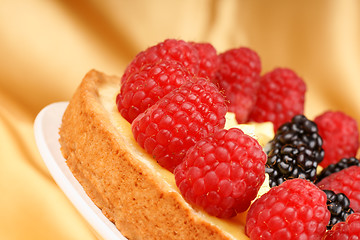 Image showing Close-up of a custard tart with raspberries and blackberries