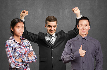 Image showing Asian team and businessman with hands up