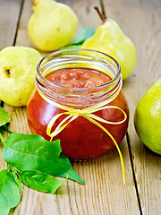 Image showing Jam pear in glass jar on board