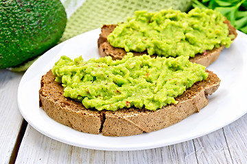 Image showing Sandwich with avocado guacamole on light board