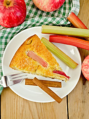 Image showing Pie with apple and rhubarb in plate on wooden board