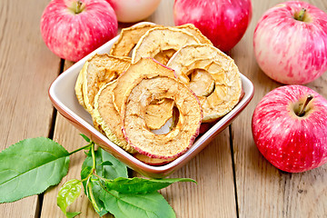 Image showing Apples fresh and dried in bowl on board with sheet