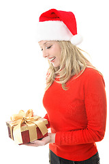 Image showing Smiling woman holding a Christmas gift