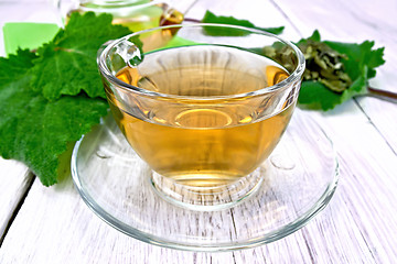 Image showing Tea with sage in cup on light board