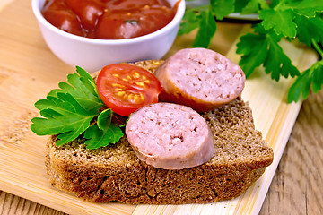 Image showing Sausages fried on bread with tomato and sauce