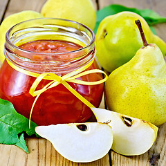 Image showing Jam pear and green leaves on board