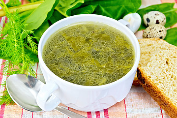 Image showing Soup of greenery with bread on cloth