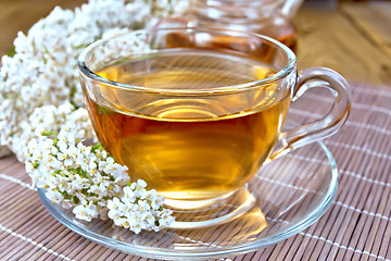 Image showing Tea with yarrow in cup on bamboo napkin