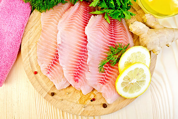Image showing Tilapia with ginger and lemon on board