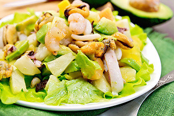 Image showing Salad seafood and avocado on green napkin