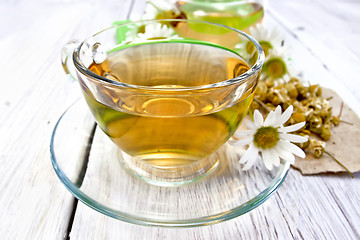 Image showing Tea chamomile in cup on light board