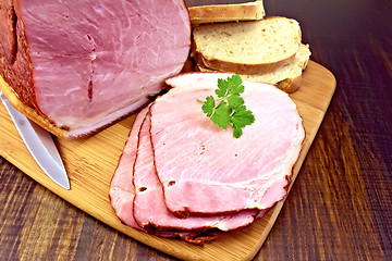 Image showing Ham smoked with bread on dark board