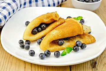 Image showing Pancakes with blueberries and napkin on board