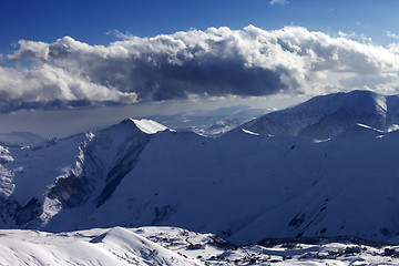 Image showing Winter mountains at evening and sunlight clouds