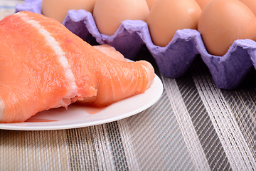 Image showing Fresh uncooked red fish fillet slices and eggs