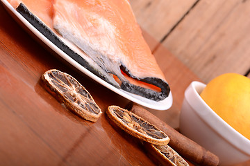 Image showing Slice of red fish salmon with fruits and cinnamon